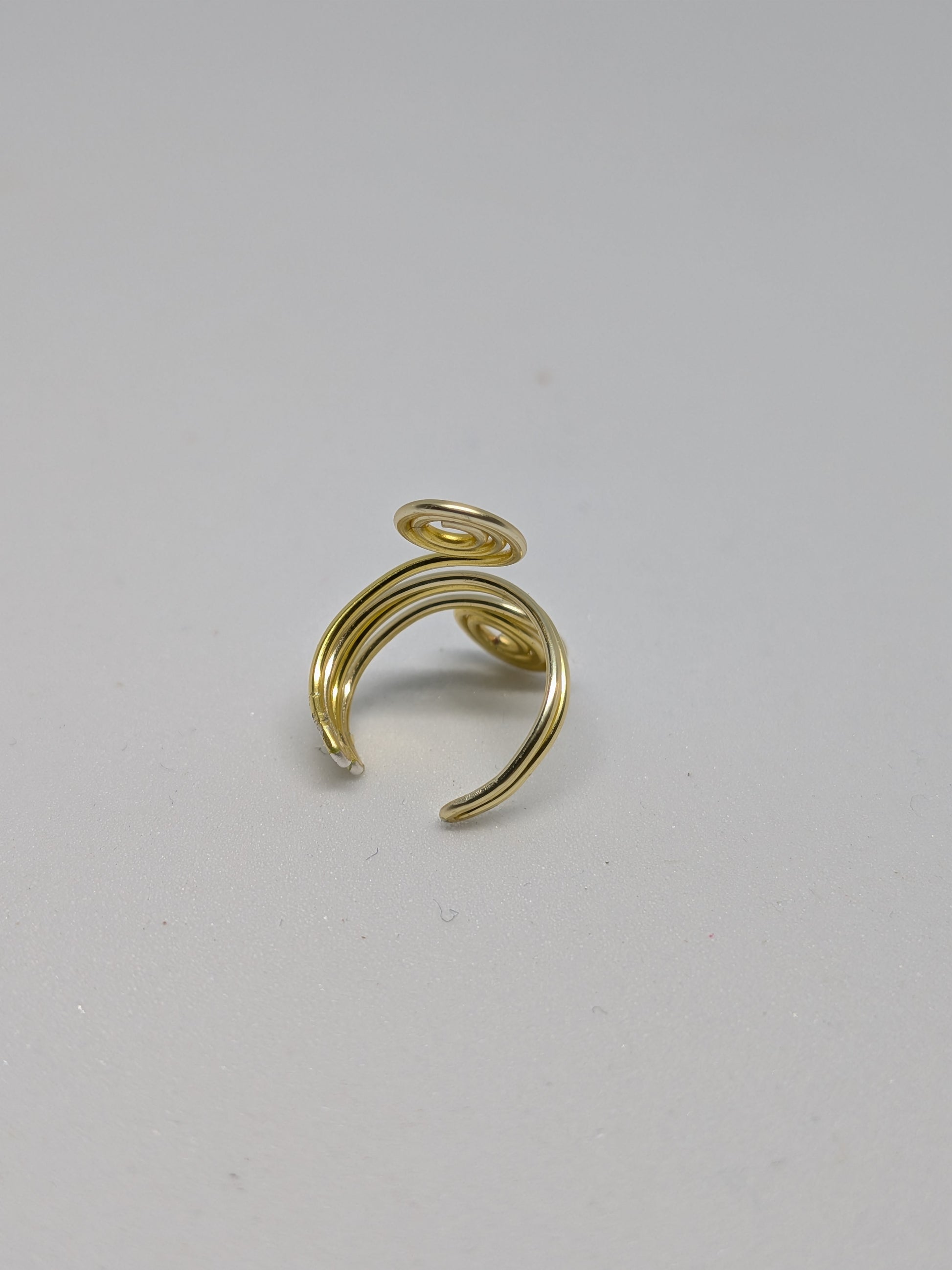 Einzelner Earcuff in Hellgold mit dekorativen Spiralen