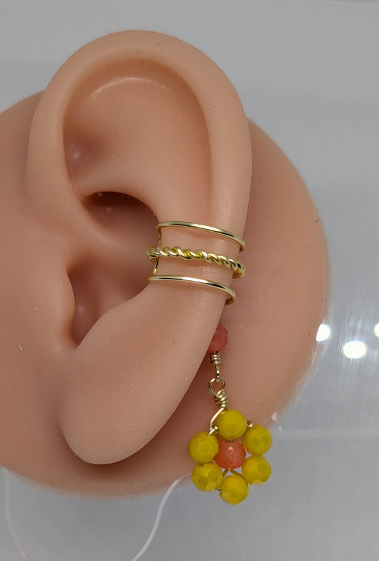 Ein Paar Earcuffs in Hellgold mit Blumenanhänger in sommerlich leuchtendem Gelb 